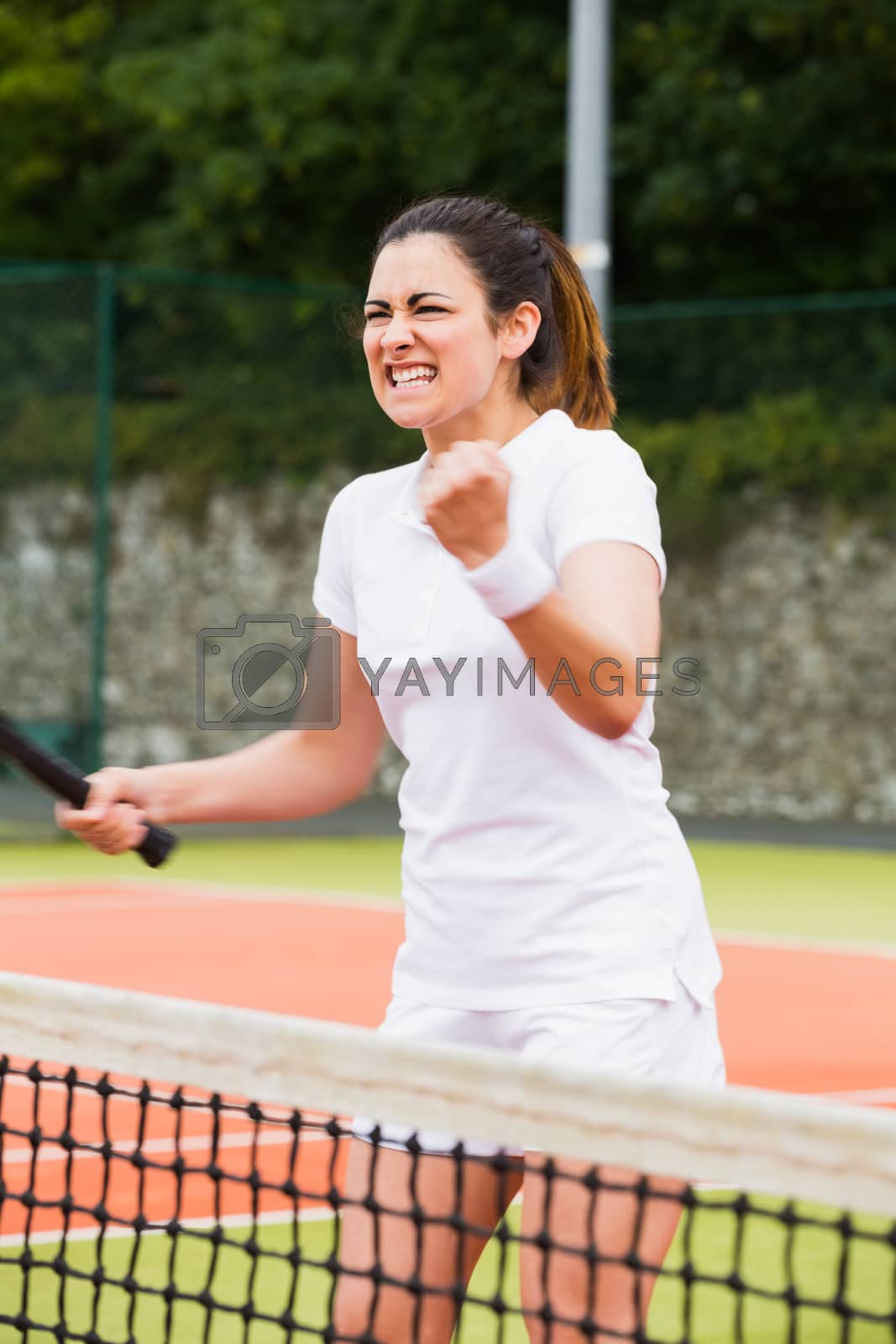 Royalty free image of Pretty tennis player celebrating a win by Wavebreakmedia
