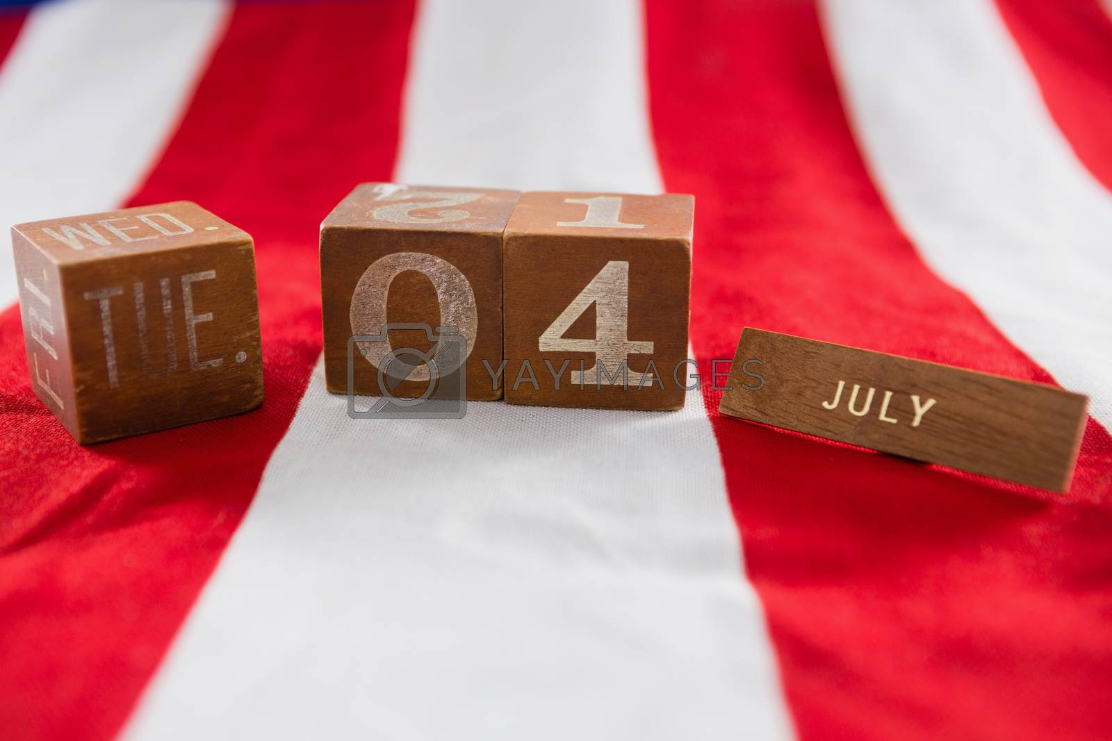 Royalty free image of Date blocks on American flag with 4th july theme by Wavebreakmedia