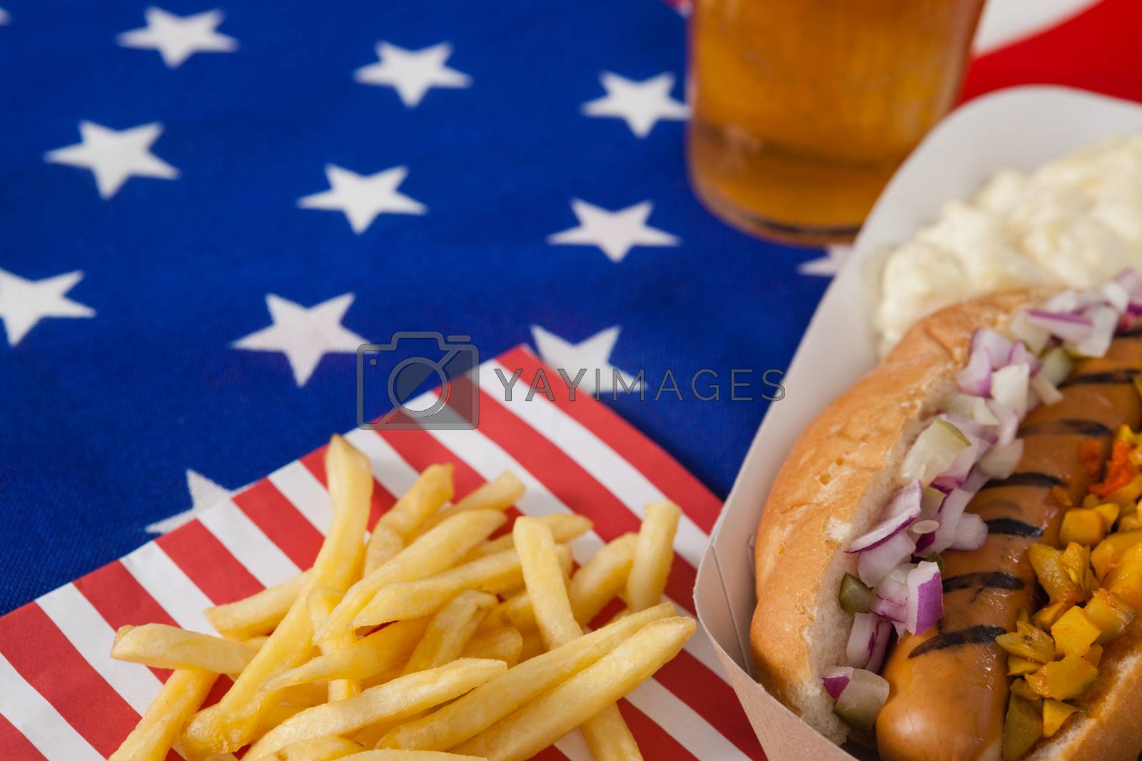 Royalty free image of Hot dog and french fries on wooden tale by Wavebreakmedia