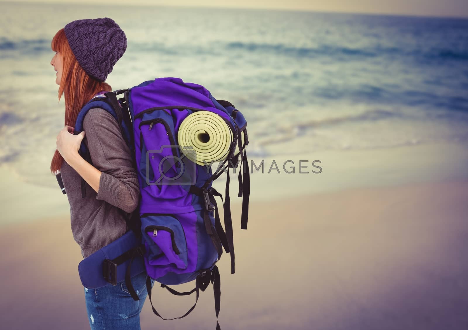 Royalty free image of Millennial backpacker on blurry beach by Wavebreakmedia