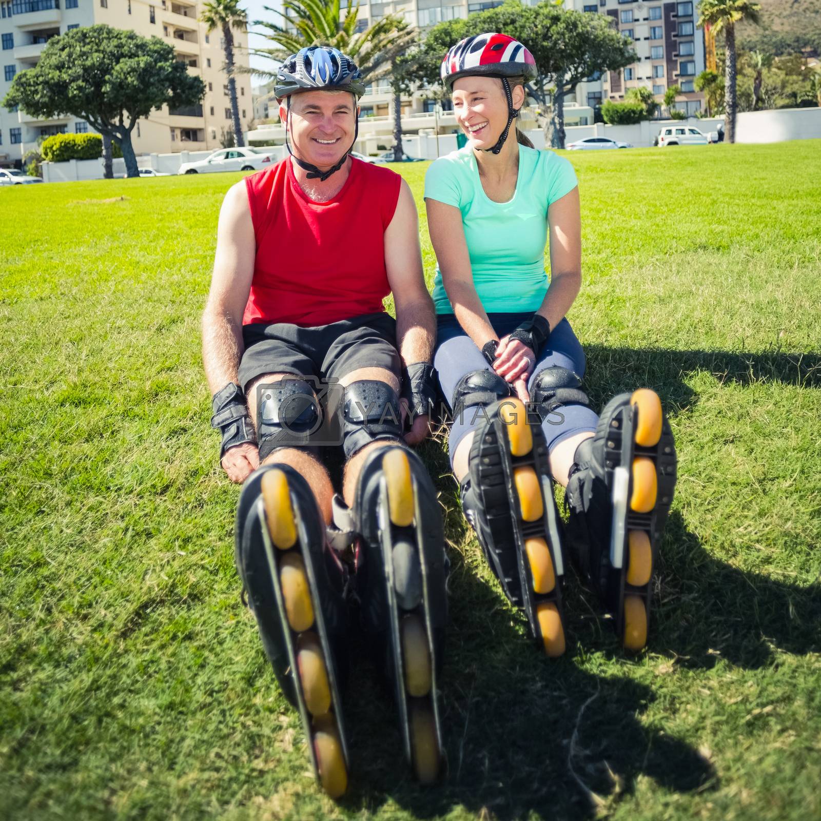Royalty free image of Fit mature couple wearing roller blades on the grass by Wavebreakmedia