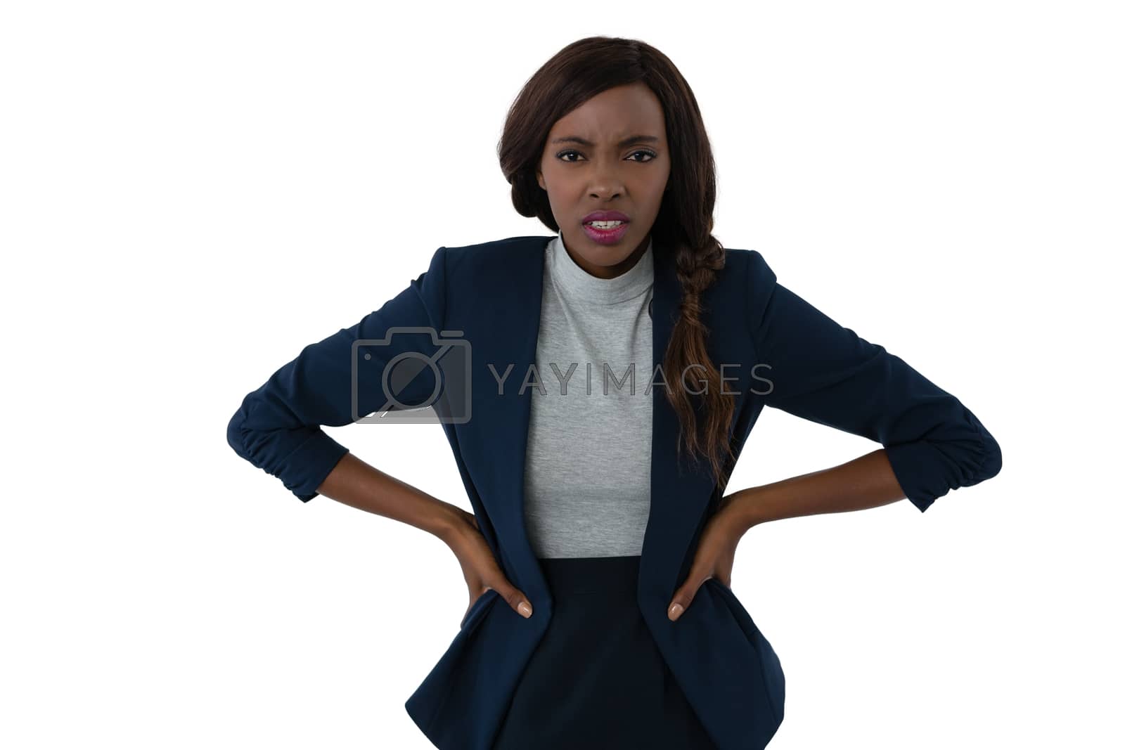 Royalty free image of Portrait of irritated businesswoman with hands on hip by Wavebreakmedia