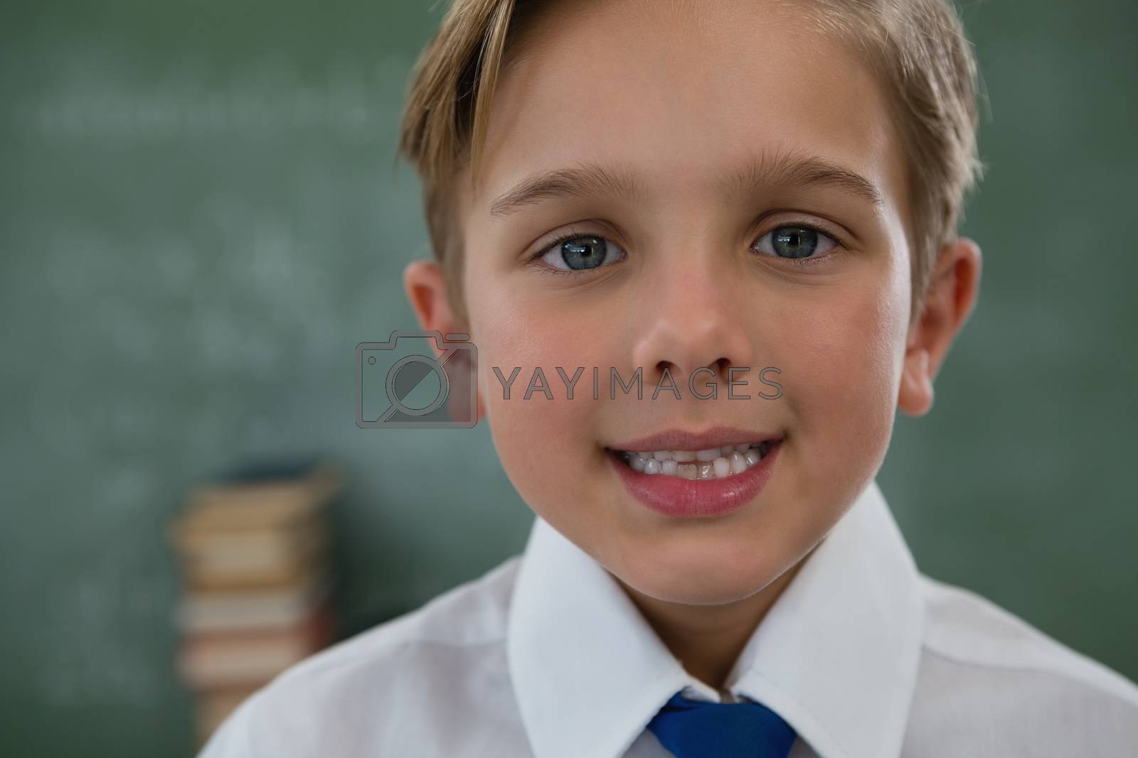 Royalty free image of Smiling schoolboy against chalkboard by Wavebreakmedia