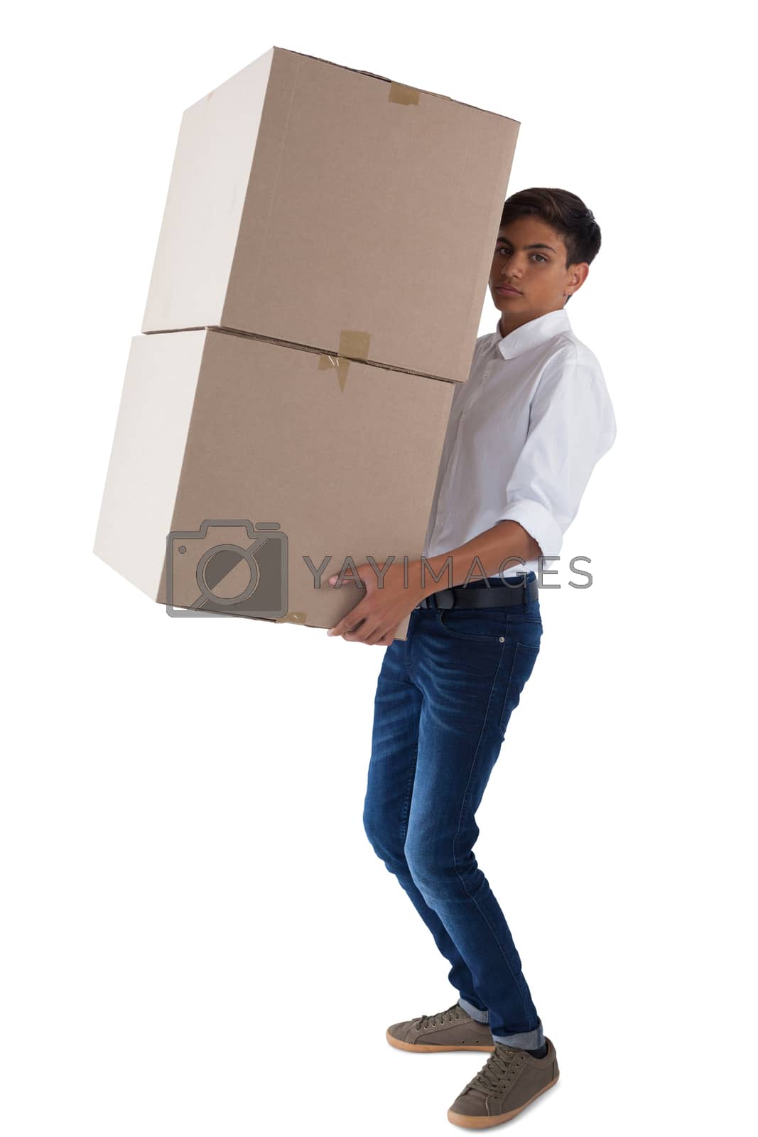 Royalty free image of Boy carrying heavy boxes by Wavebreakmedia
