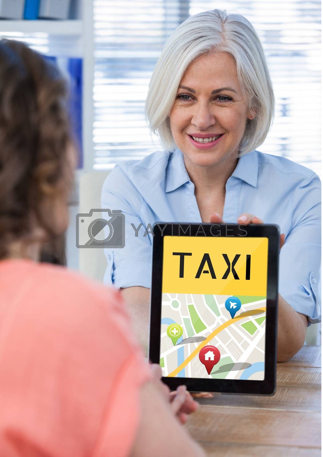 Royalty free image of Woman holding a tablet with a taxi app by Wavebreakmedia