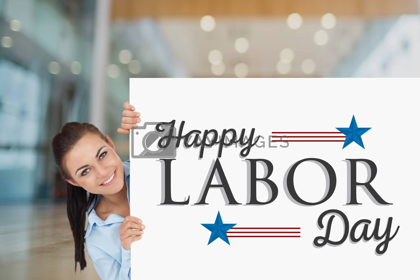 Royalty free image of Woman holding a Labor Day card by Wavebreakmedia