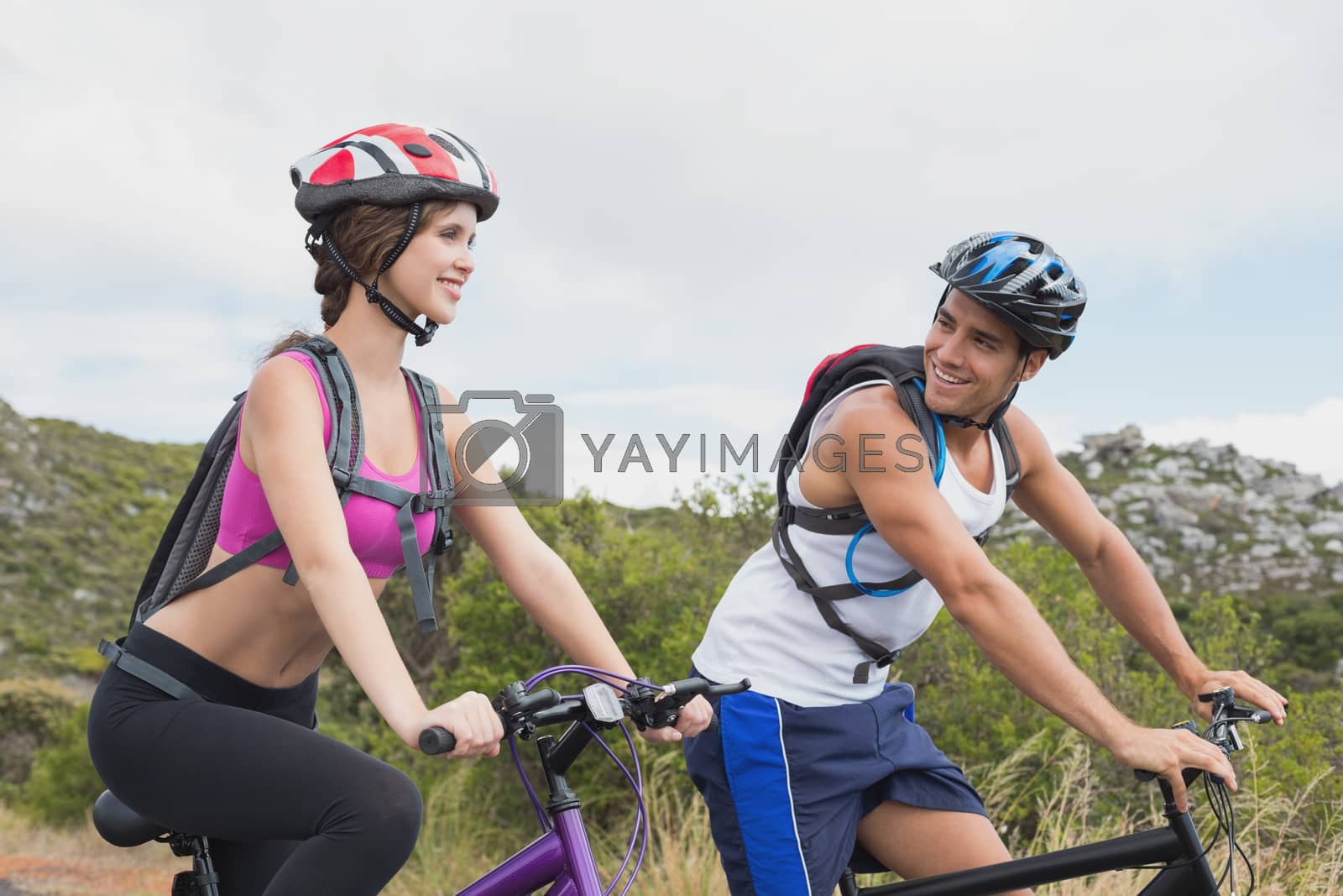 Royalty free image of Athletic couple mountain biking by Wavebreakmedia
