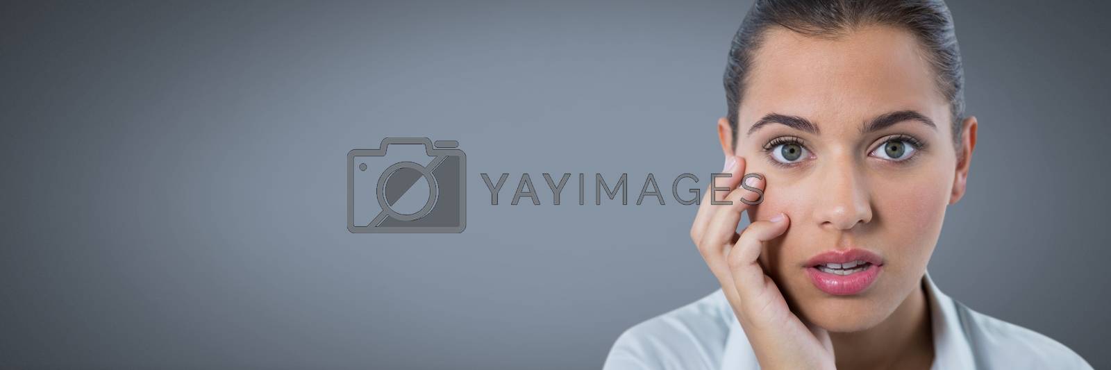 Royalty free image of Businesswoman thinking attentively with grey background by Wavebreakmedia