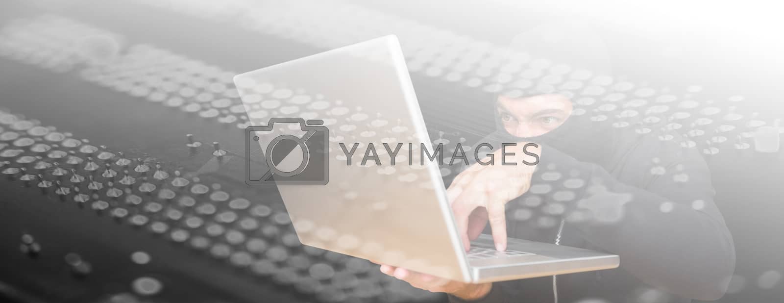 Royalty free image of Composite image of hacker using laptop to steal identity at desk by Wavebreakmedia