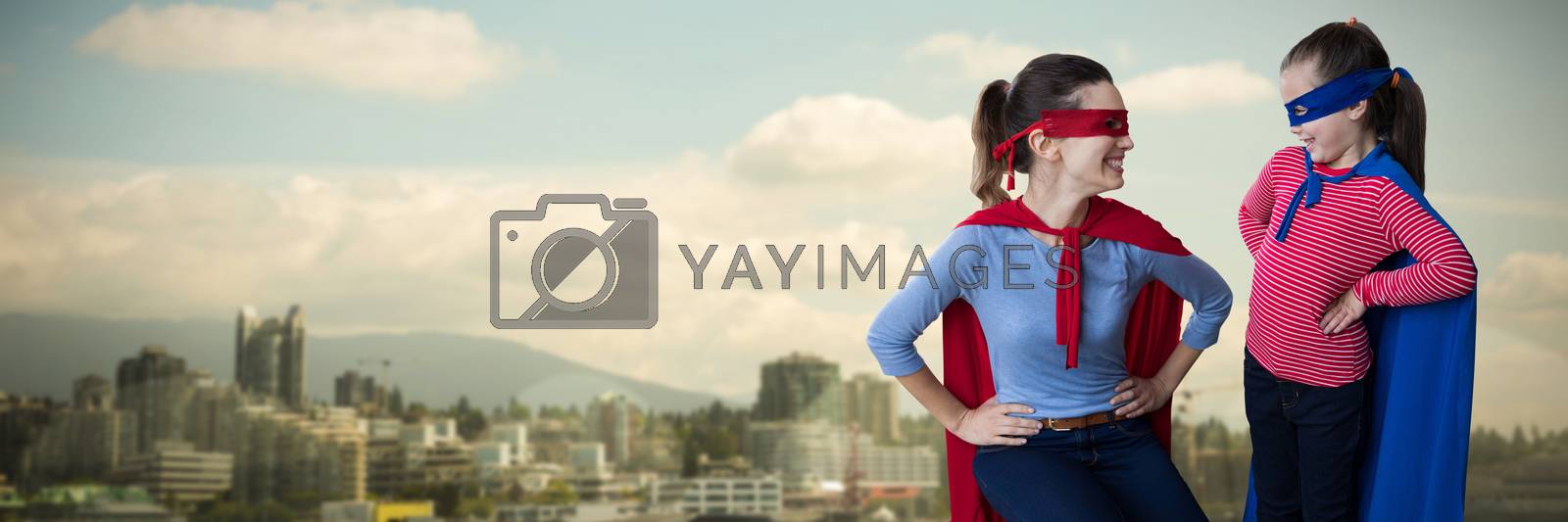 Royalty free image of Composite image of mother and daughter pretending to be superhero by Wavebreakmedia