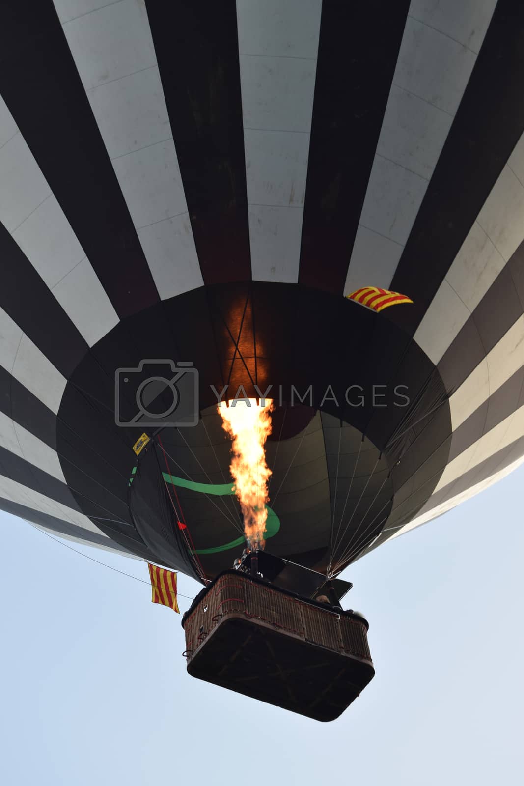 Royalty free image of Hot-air balloon taking off with fire flame by mynameg3rard
