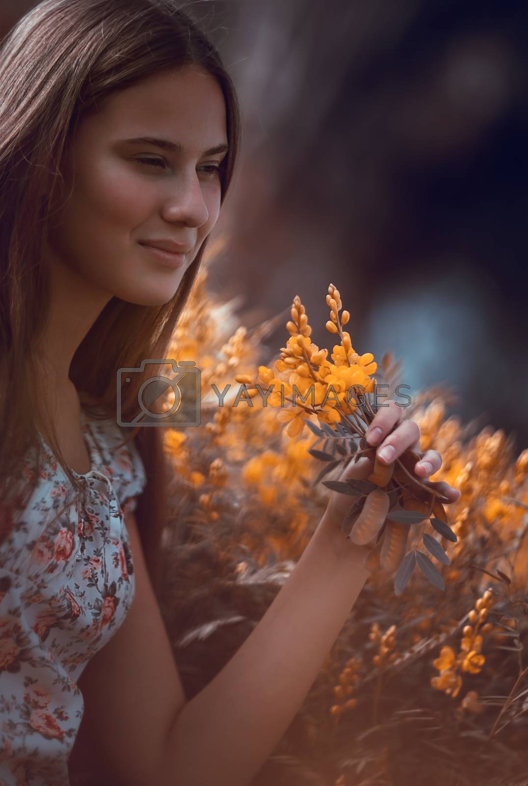 Royalty free image of Pretty girl enjoying wildflowers by Anna_Omelchenko