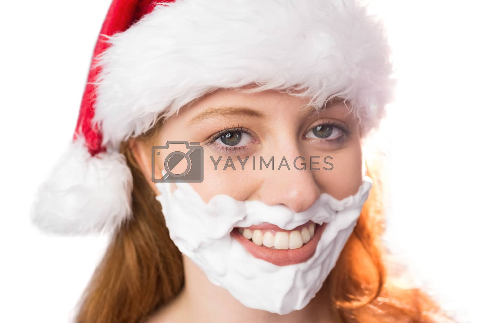 Royalty free image of Festive redhead in foam beard by Wavebreakmedia
