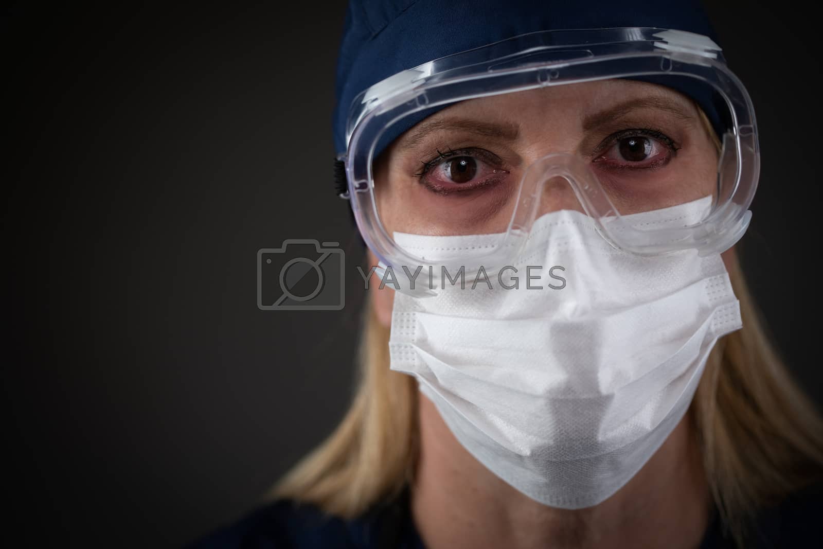 Royalty free image of Female Medical Worker Wearing Protective Gear Showing Symptoms of Disease. by Feverpitched