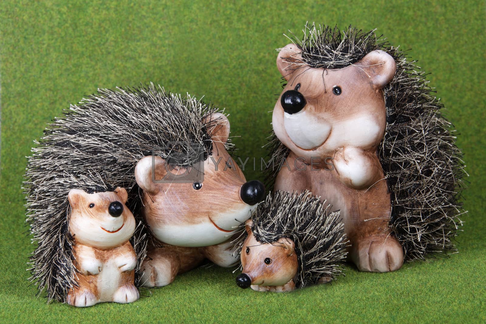 Royalty free image of Family of cute toy Hedgehogs together on grass by VivacityImages
