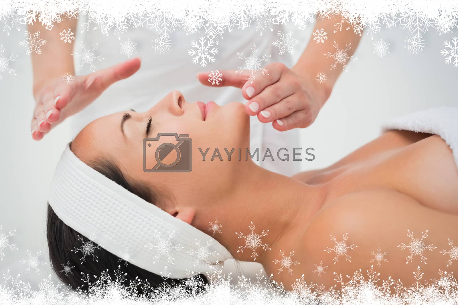 Royalty free image of Peaceful brunette getting reiki therapy by Wavebreakmedia