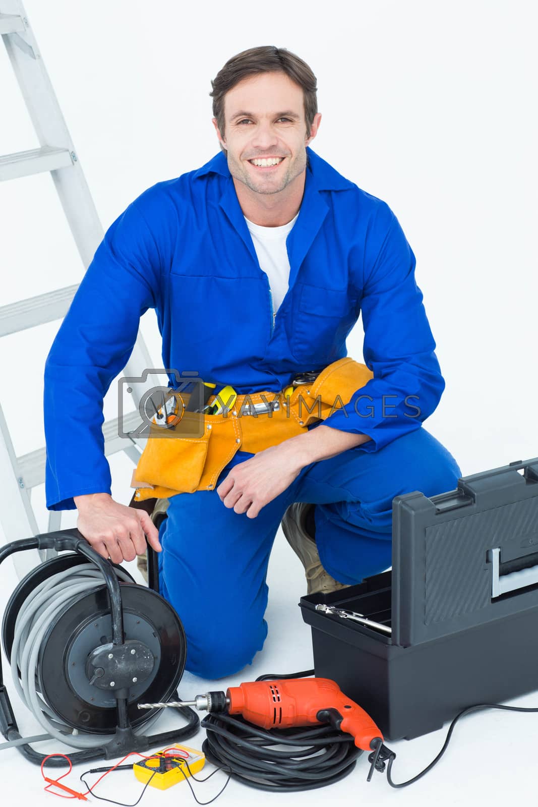 Royalty free image of Confident electrician with tools by Wavebreakmedia