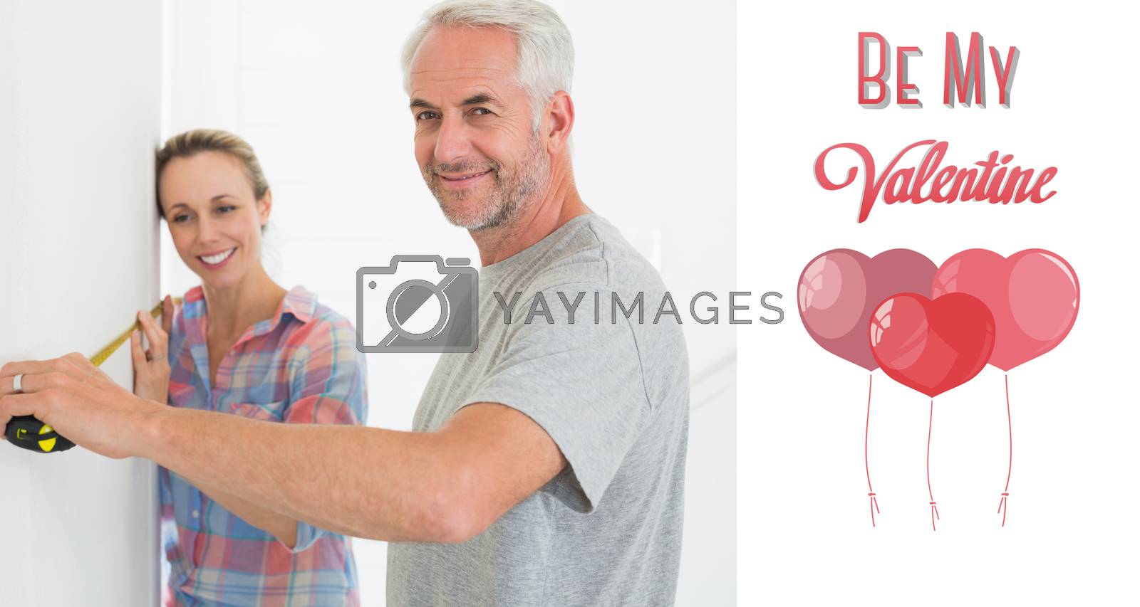Royalty free image of Composite image of happy couple making some measurements together by Wavebreakmedia