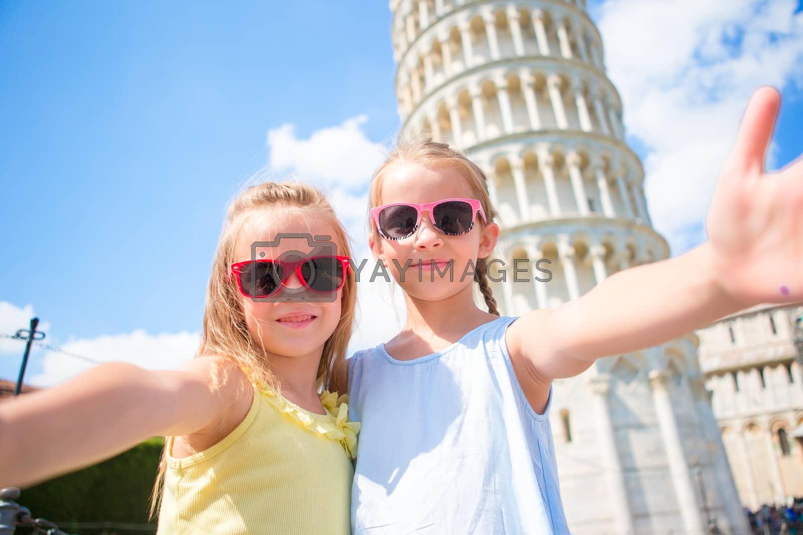 Royalty free image of Little kids taking selfie background the Leaning Tower in Pisa, Italy. Photo about european vacation by travnikovstudio