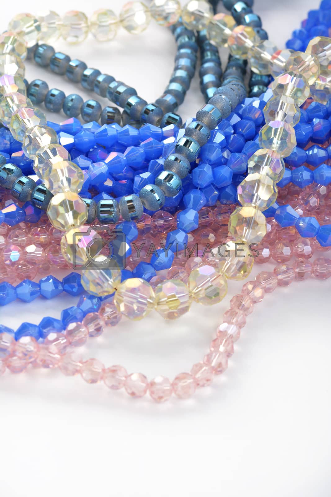 Royalty free image of Color faceted glass sparkle beads. Materials for creative work on white background. by polyats