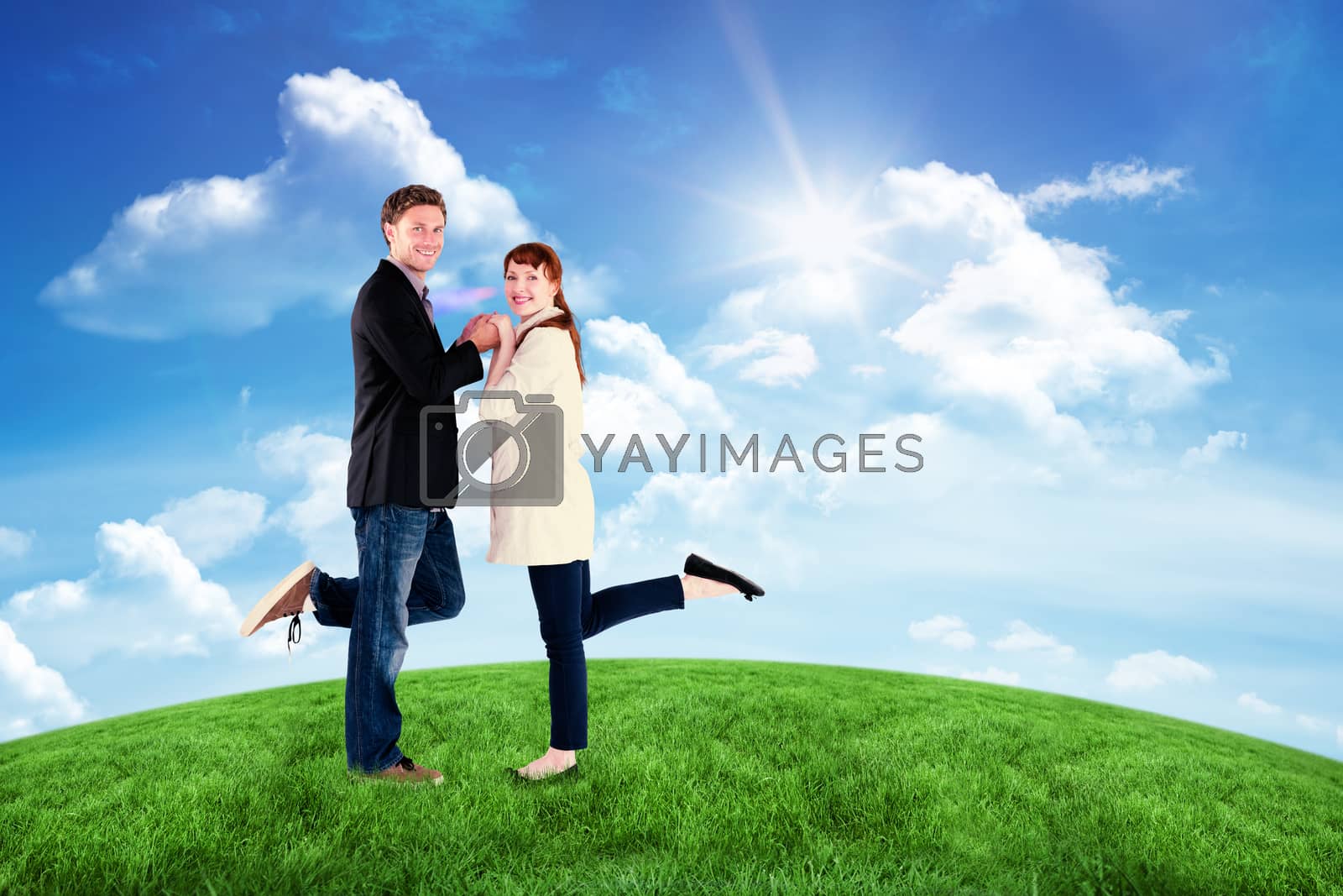 Royalty free image of Composite image of smiling couple with raised legs by Wavebreakmedia