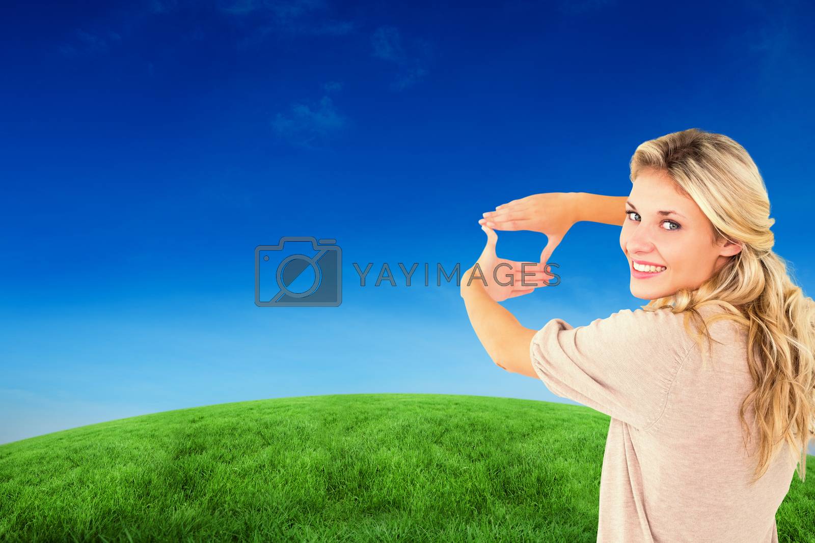 Royalty free image of Composite image of attractive young blonde framing with her hands by Wavebreakmedia