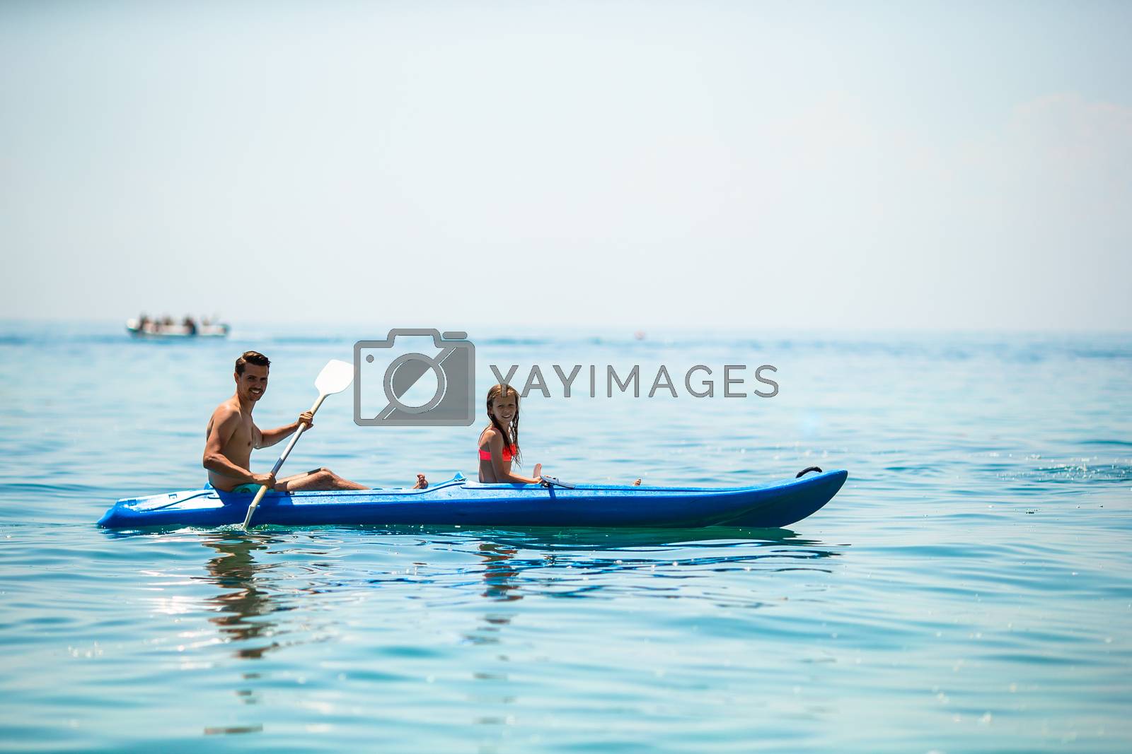 Royalty free image of Sporty attractive family kayaking on sea together by travnikovstudio