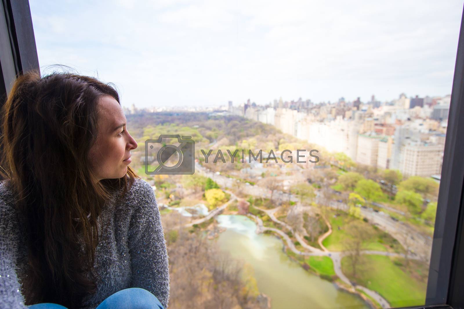 Royalty free image of Young girl with view of Central Park by travnikovstudio