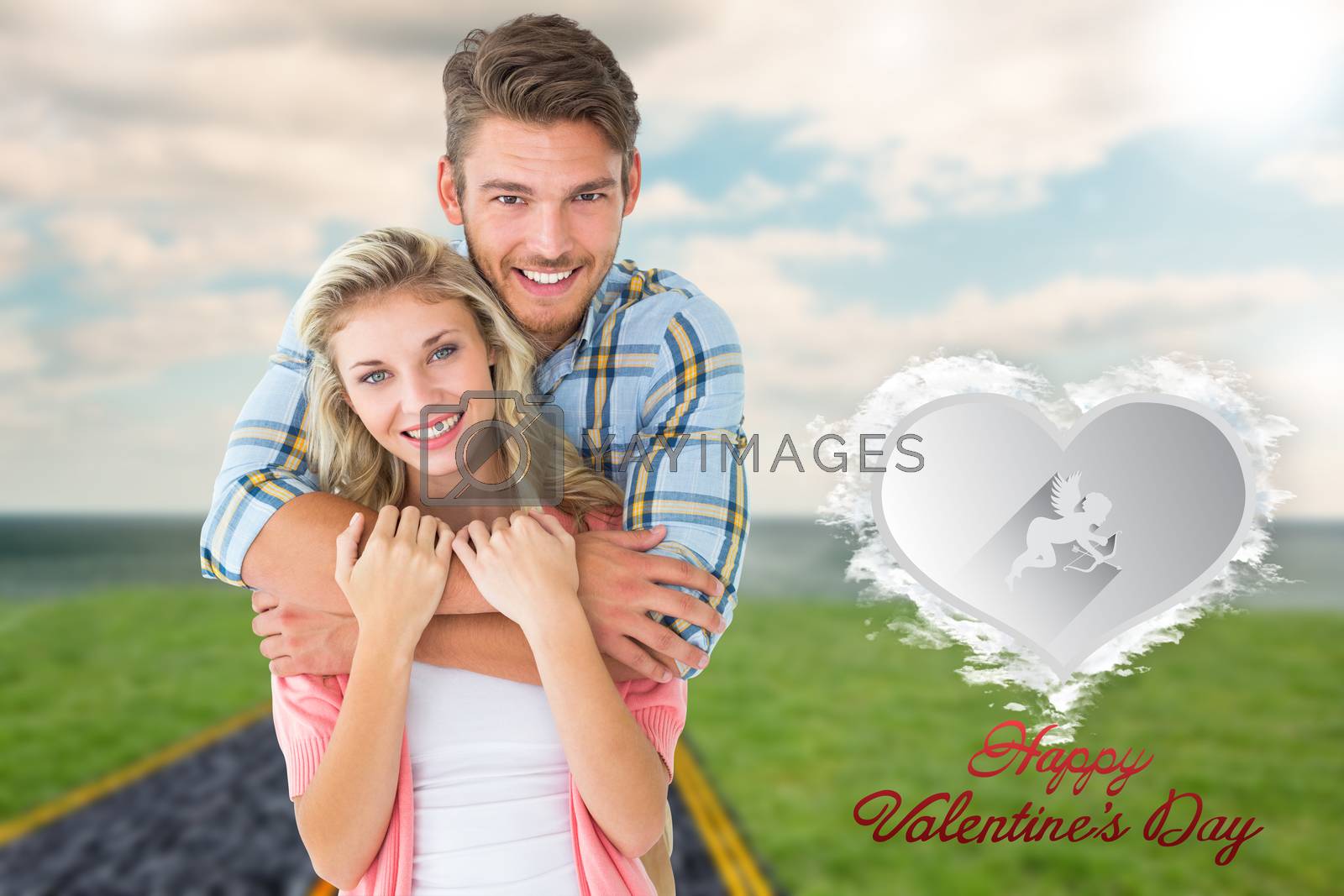 Royalty free image of Composite image of attractive young couple smiling at camera by Wavebreakmedia