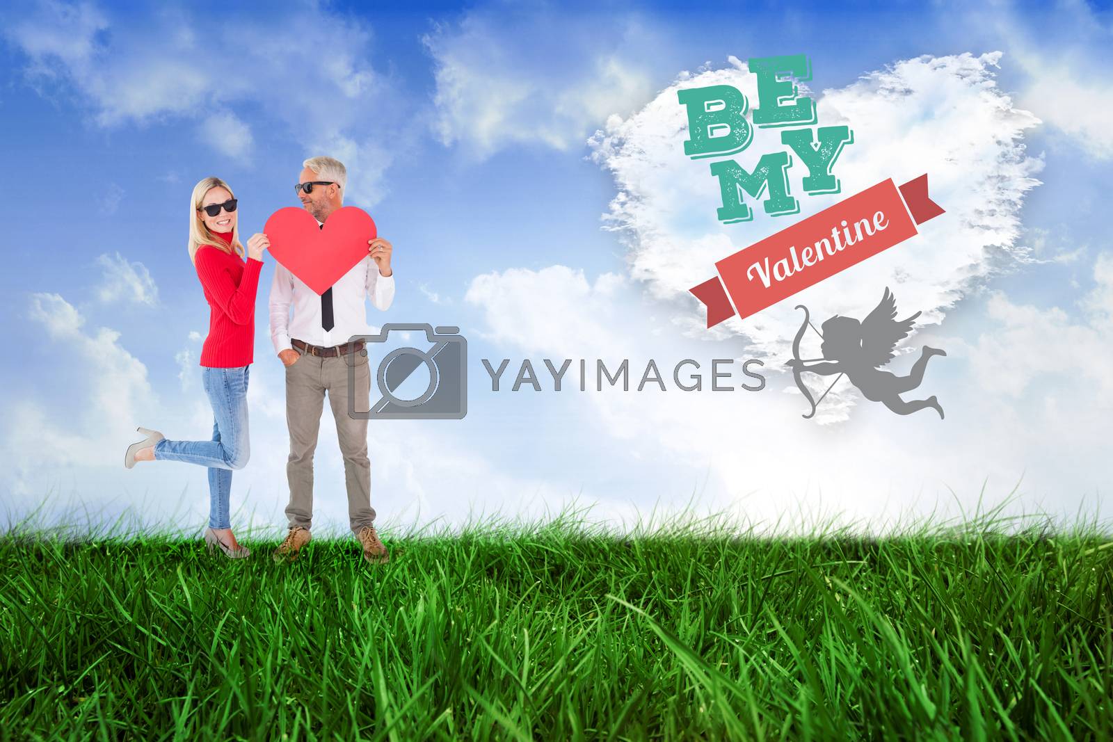 Royalty free image of Composite image of cool couple holding a red heart together by Wavebreakmedia