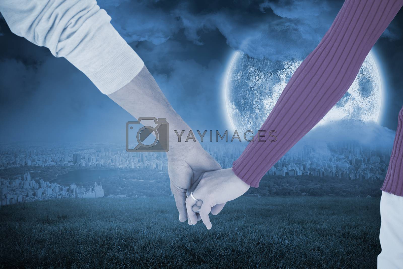 Royalty free image of Composite image of couple holding hands rear view by Wavebreakmedia
