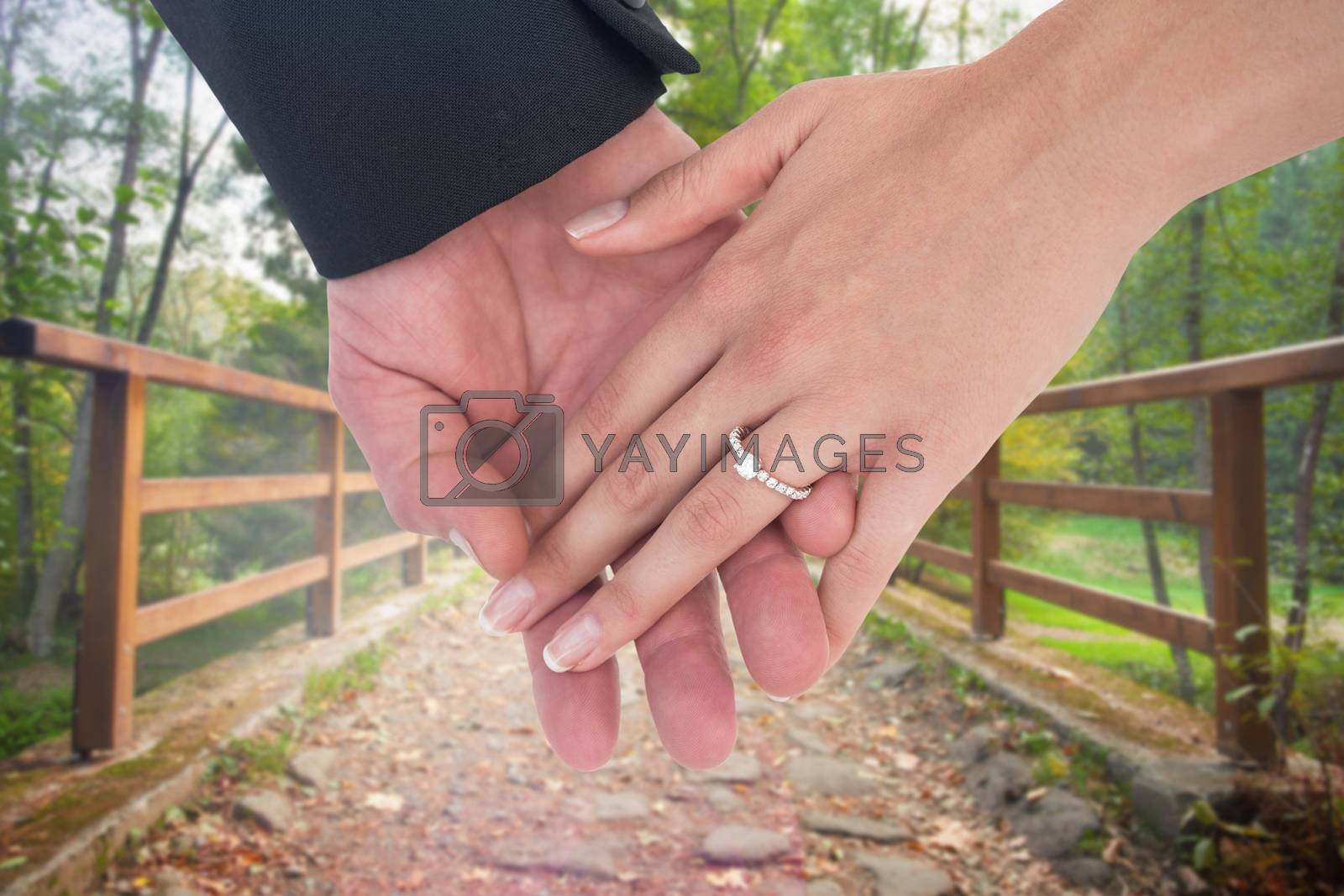 Royalty free image of Composite image of close-up of bride and groom with hands together by Wavebreakmedia