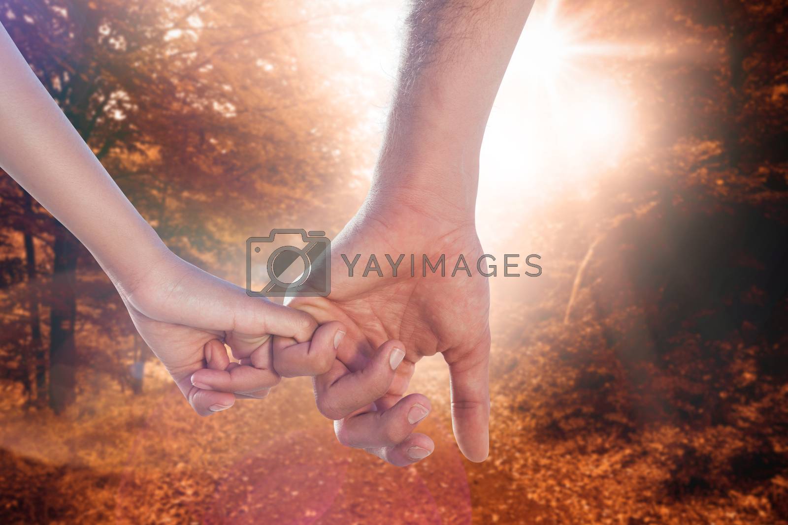 Royalty free image of Composite image of loving young couple holding hands by Wavebreakmedia