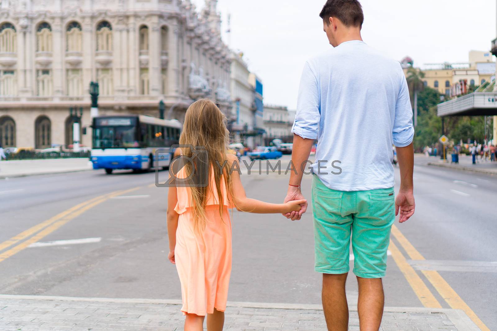Royalty free image of Tourist girl and father in popular area in Havana, Cuba. Family travel on the Caribbean islands by travnikovstudio