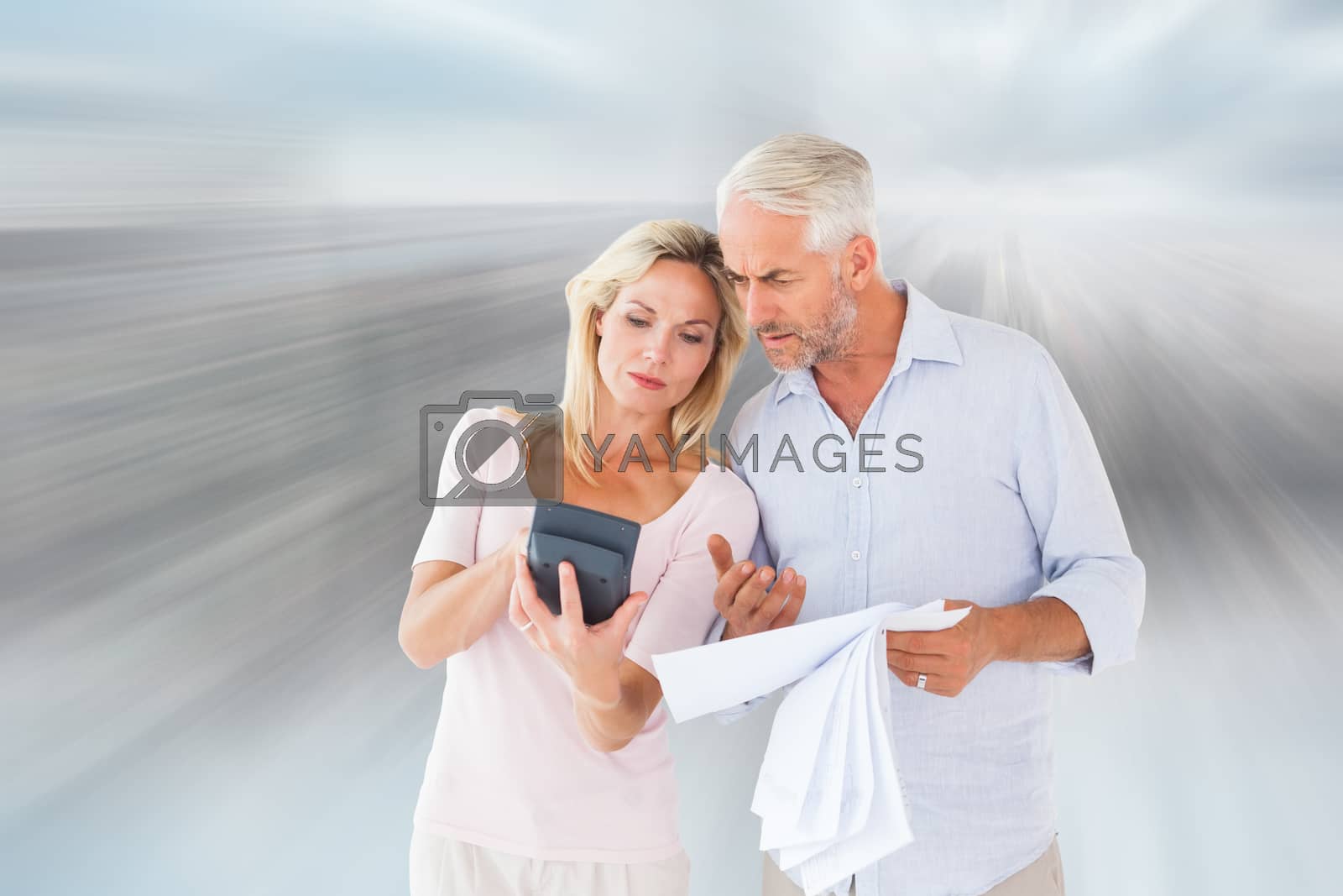 Royalty free image of Composite image of anxious couple working out their bills by Wavebreakmedia