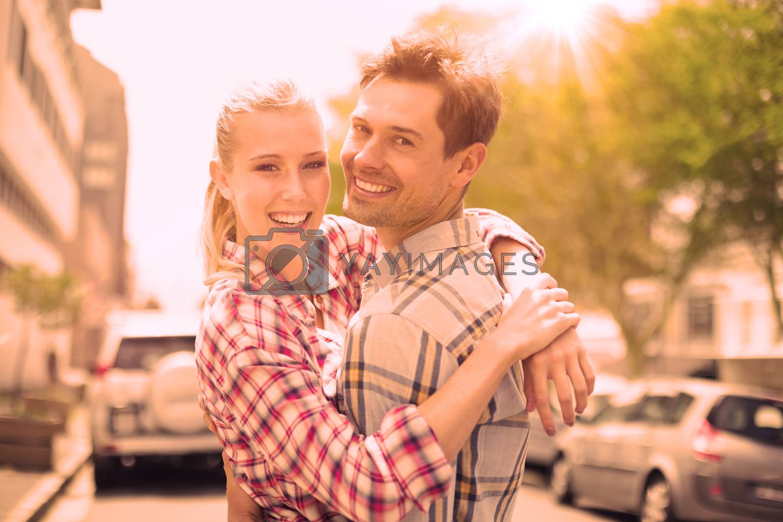 Royalty free image of Couple in check shirts and denim hugging each other by Wavebreakmedia