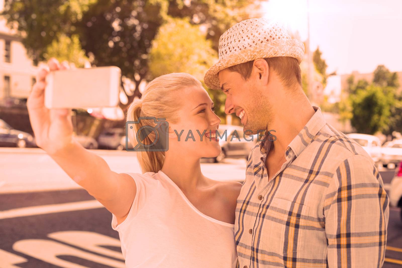 Royalty free image of Young hip couple taking a selfie by Wavebreakmedia