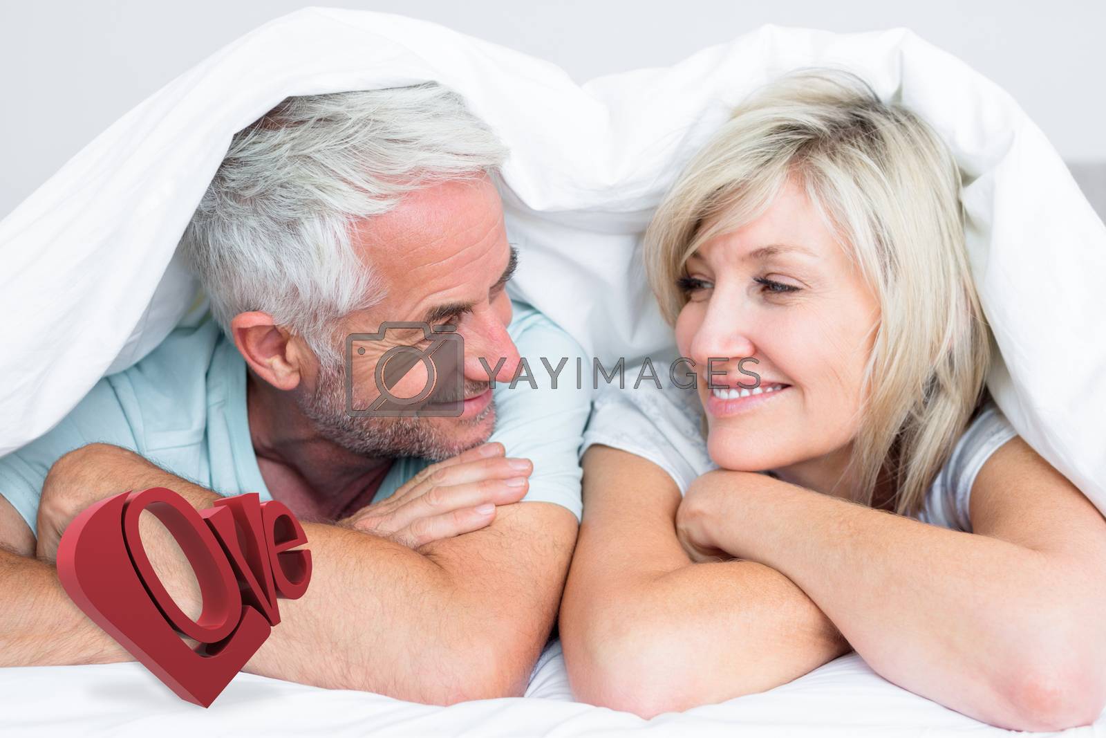 Royalty free image of Composite image of closeup of a mature couple lying in bed by Wavebreakmedia