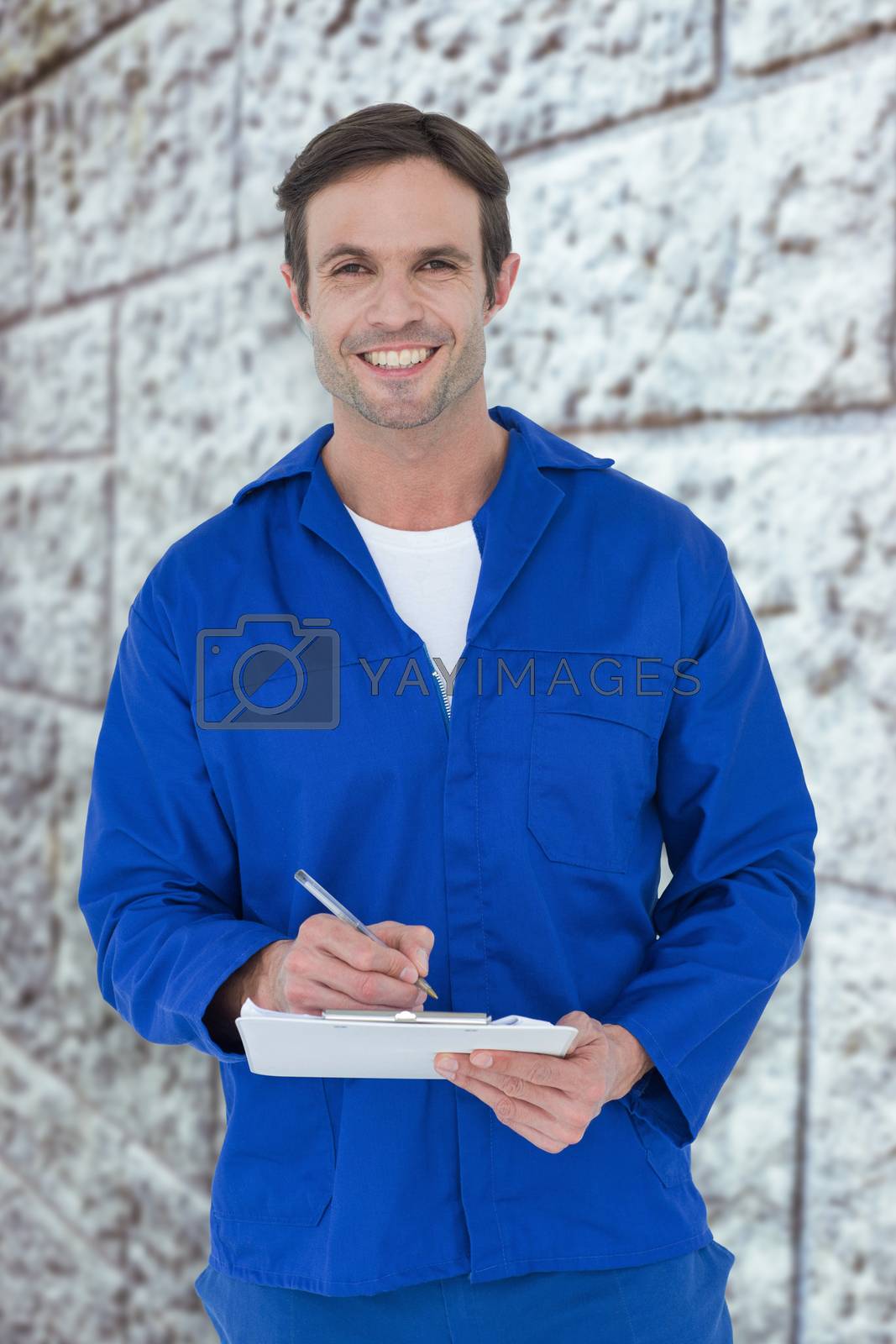 Royalty free image of Composite image of confident of mechanic writing notes on clipboard by Wavebreakmedia