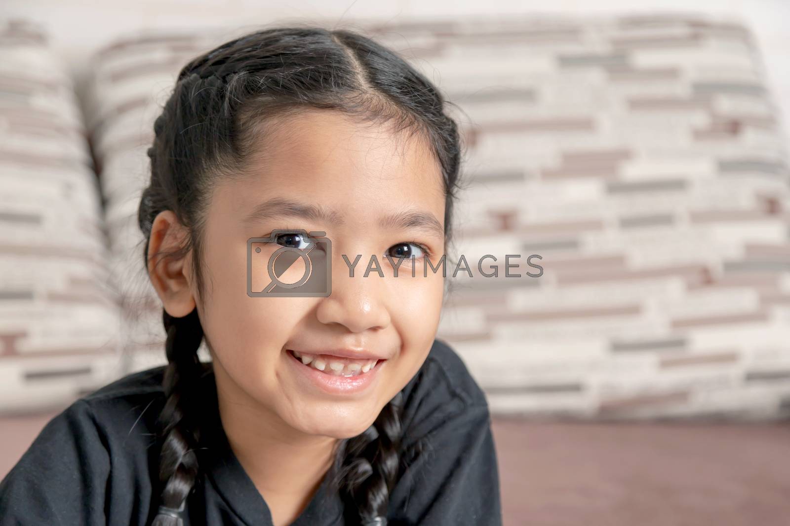 Royalty free image of Asian girl in a black braid is smiling by Nikkikii