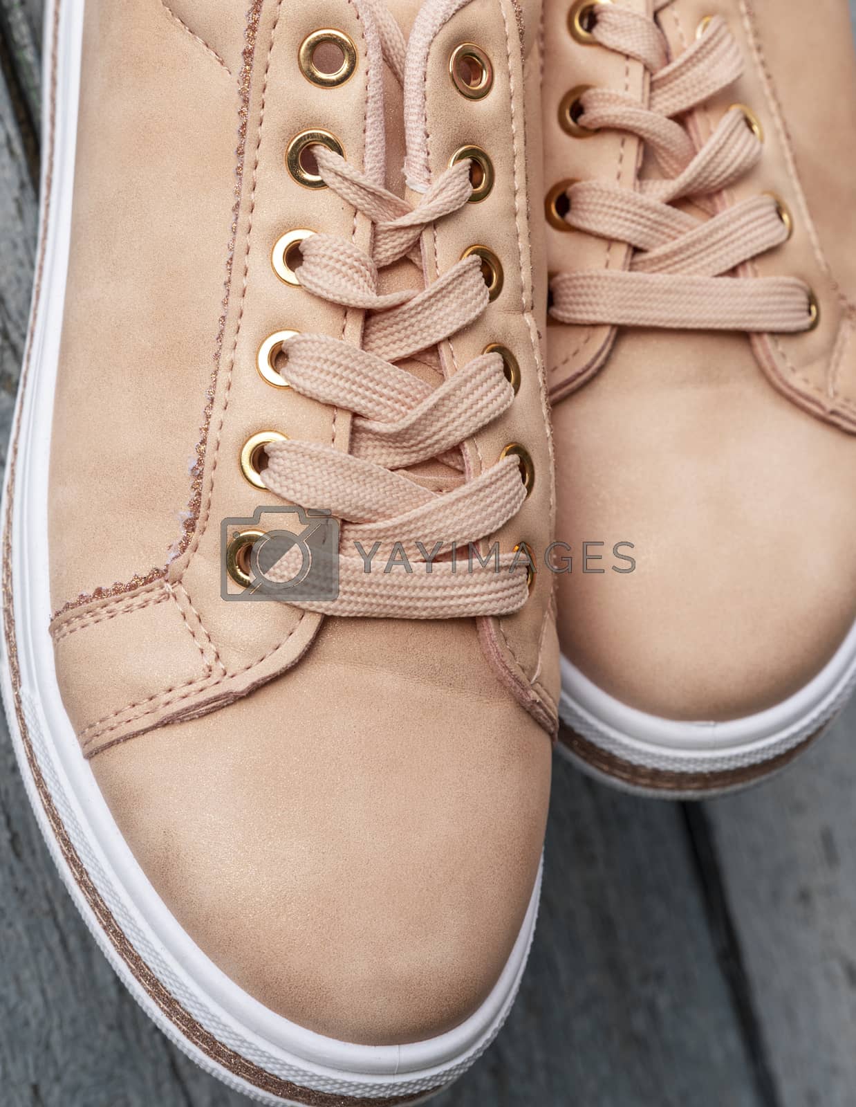 Royalty free image of fragment of beige leather women's shoes with laces by ndanko