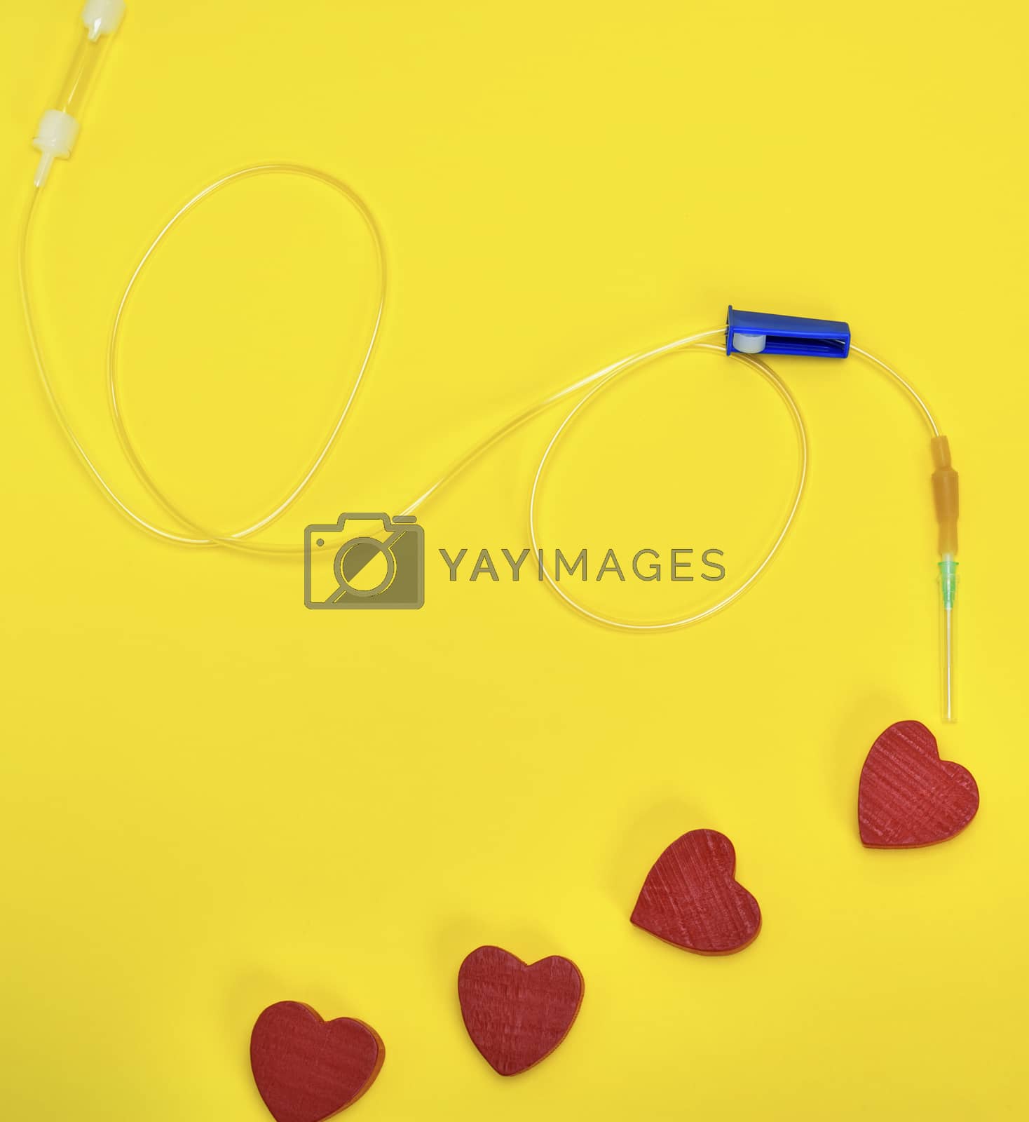 Royalty free image of plastic catheter with needle and red heart  by ndanko