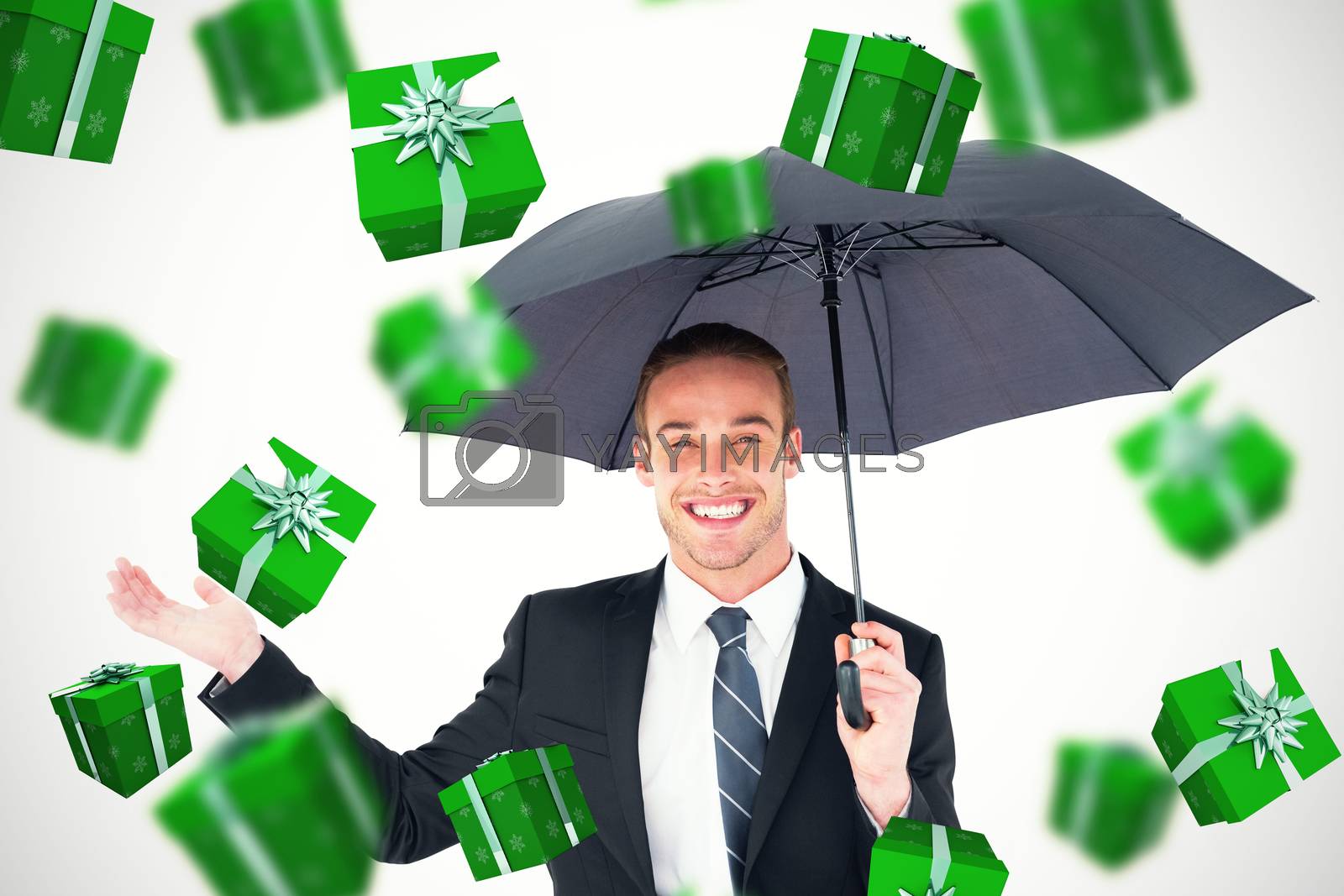 Royalty free image of Composite image of businessman sheltering under black umbrella by Wavebreakmedia