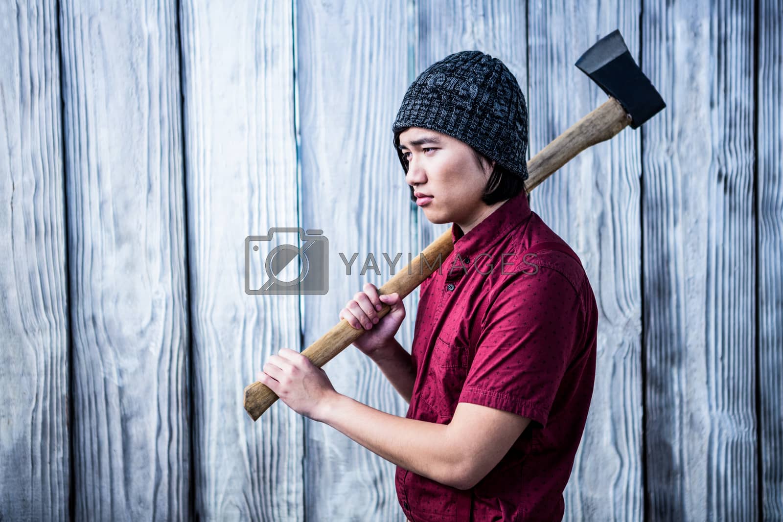 Royalty free image of Hipster holding a axe by Wavebreakmedia