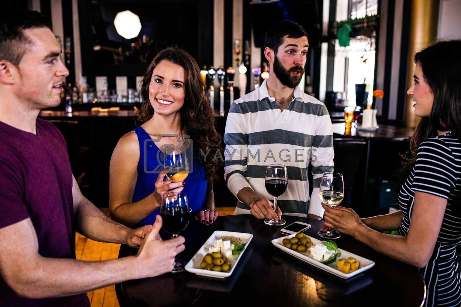 Royalty free image of Friends having an aperitif with wine by Wavebreakmedia