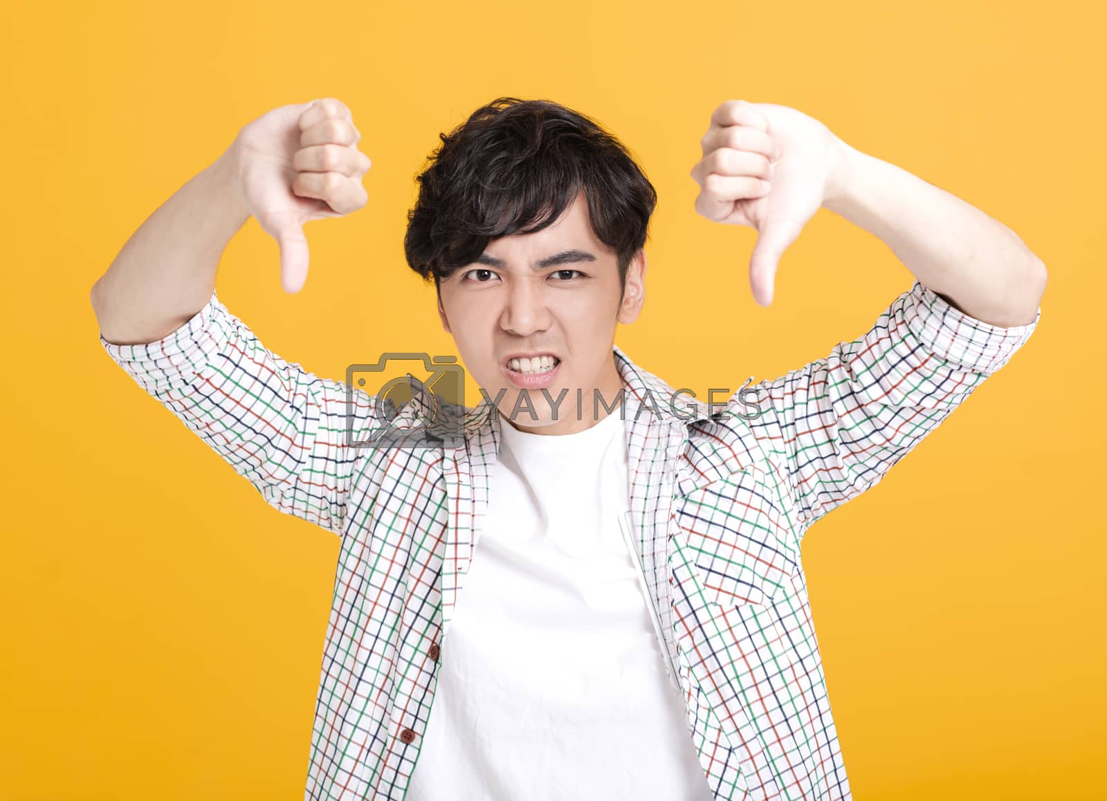 Royalty free image of young man showing thumbs down by tomwang