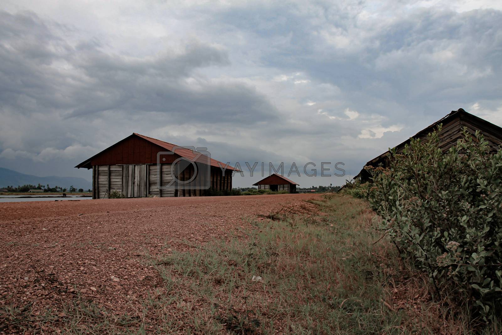 Royalty free image of Cinematic photo of an abandoned salt storage house in the famous salt fields of Kampot, shows the effect of covid-19 lock downs on the local industry, economy and livelihood of the Cambodian people by Sonnet15