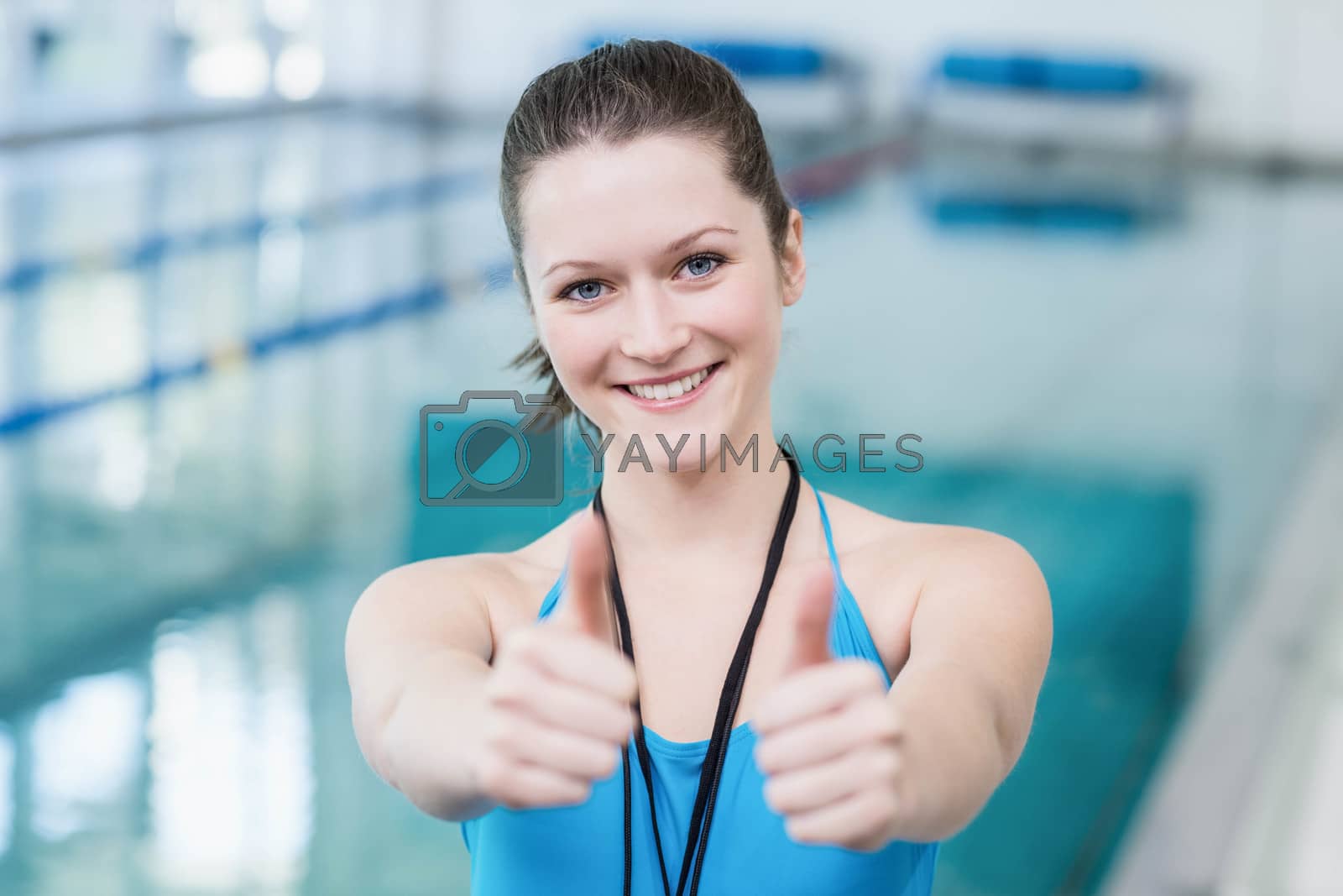 Royalty free image of Pretty trainer with thumbs up by Wavebreakmedia