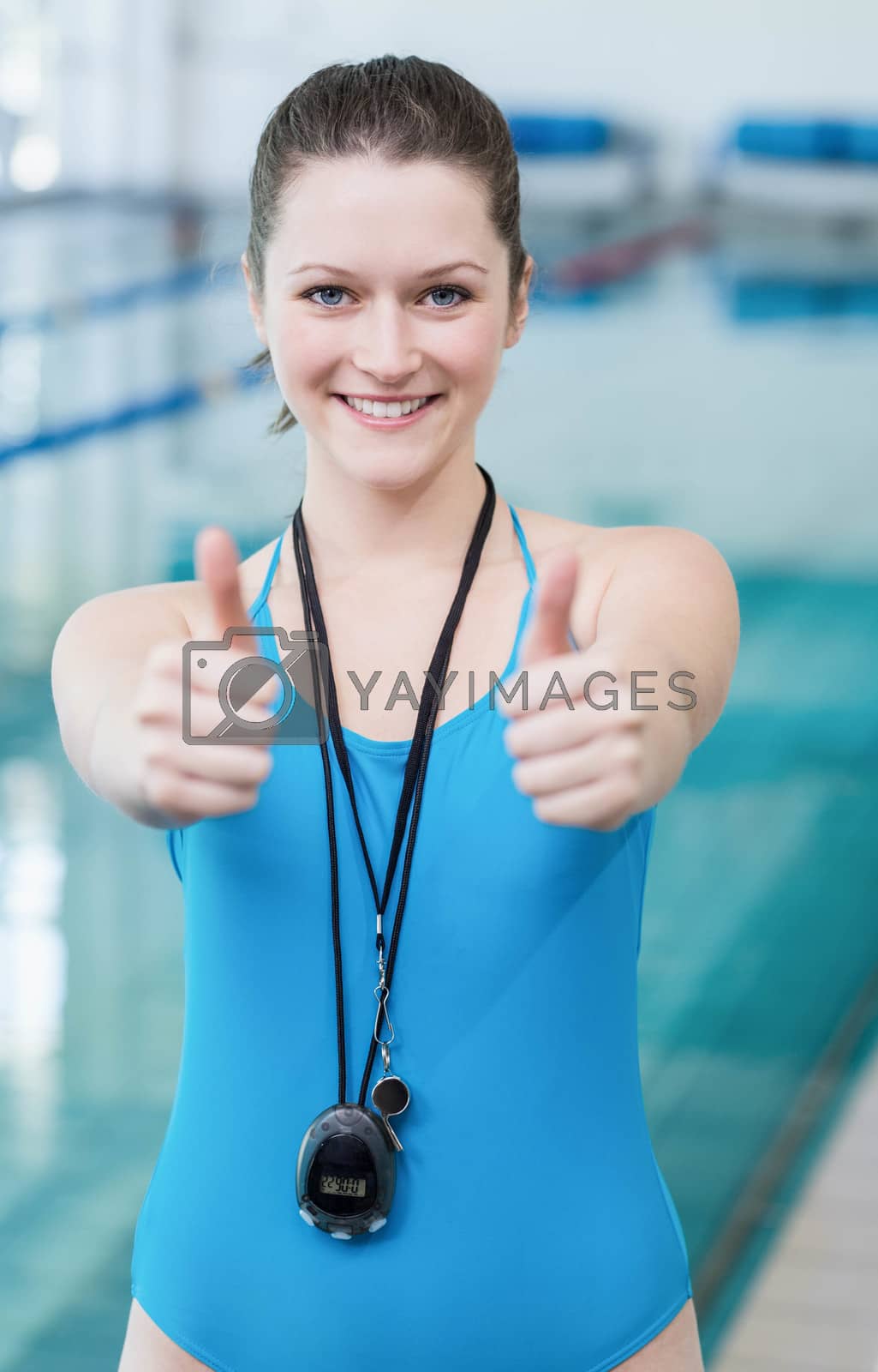 Royalty free image of Pretty trainer with thumbs up by Wavebreakmedia