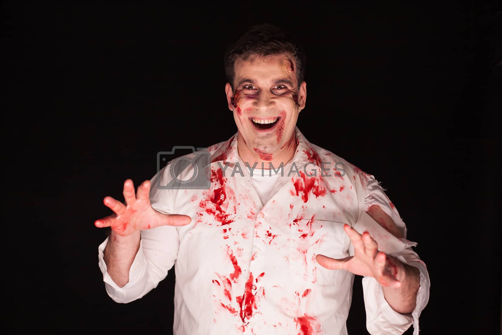 Royalty free image of Violent and spooky man with blood on his body by DCStudio